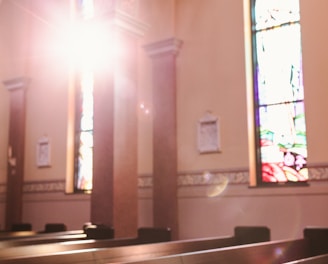 sunlight shining through a stained glass window in a church