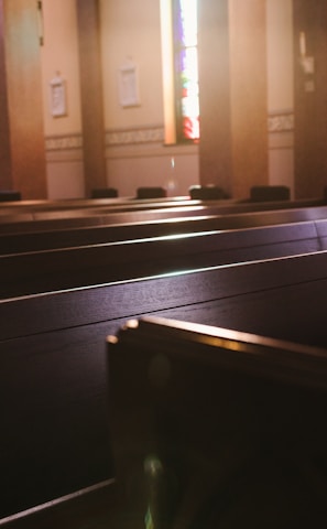 a church with pews and stained glass windows