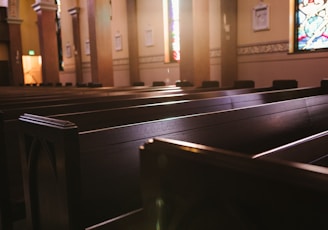 a church with pews and stained glass windows