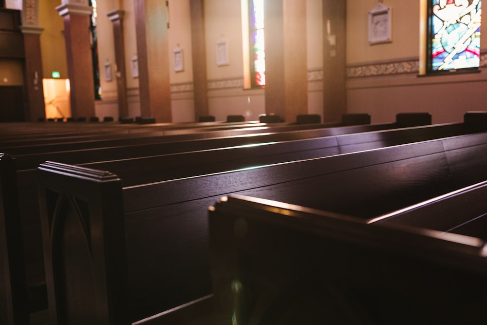 a church with pews and stained glass windows