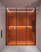 a walk in shower sitting next to a bathroom
