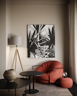 a living room with a red chair and a black table