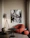 A cozy living room corner featuring a plush padded coffee ottoman with warm lighting.