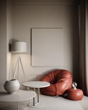 a living room with a red chair and a white table