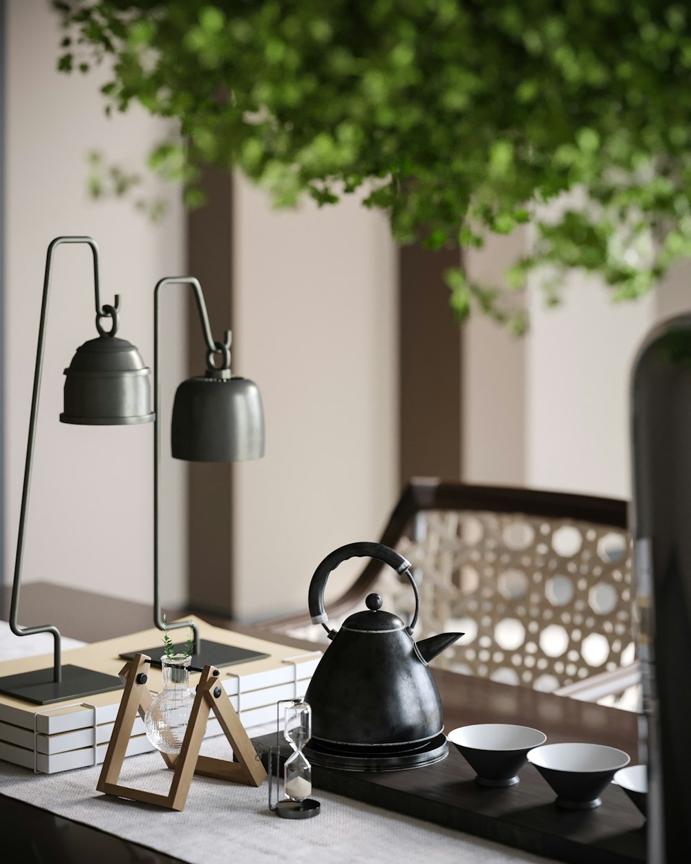 a table topped with a tea kettle next to a potted plant