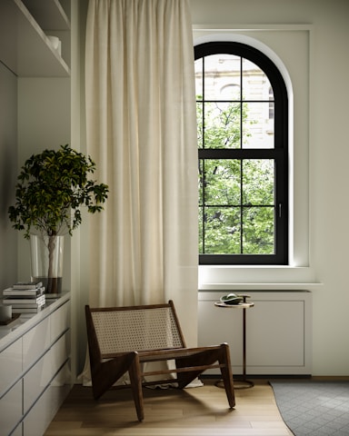 a chair sitting in front of a window in a room