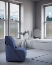 a blue chair sitting in front of a window