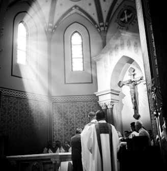 a black and white photo of people in a church