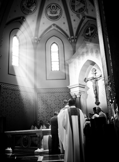 a black and white photo of people in a church