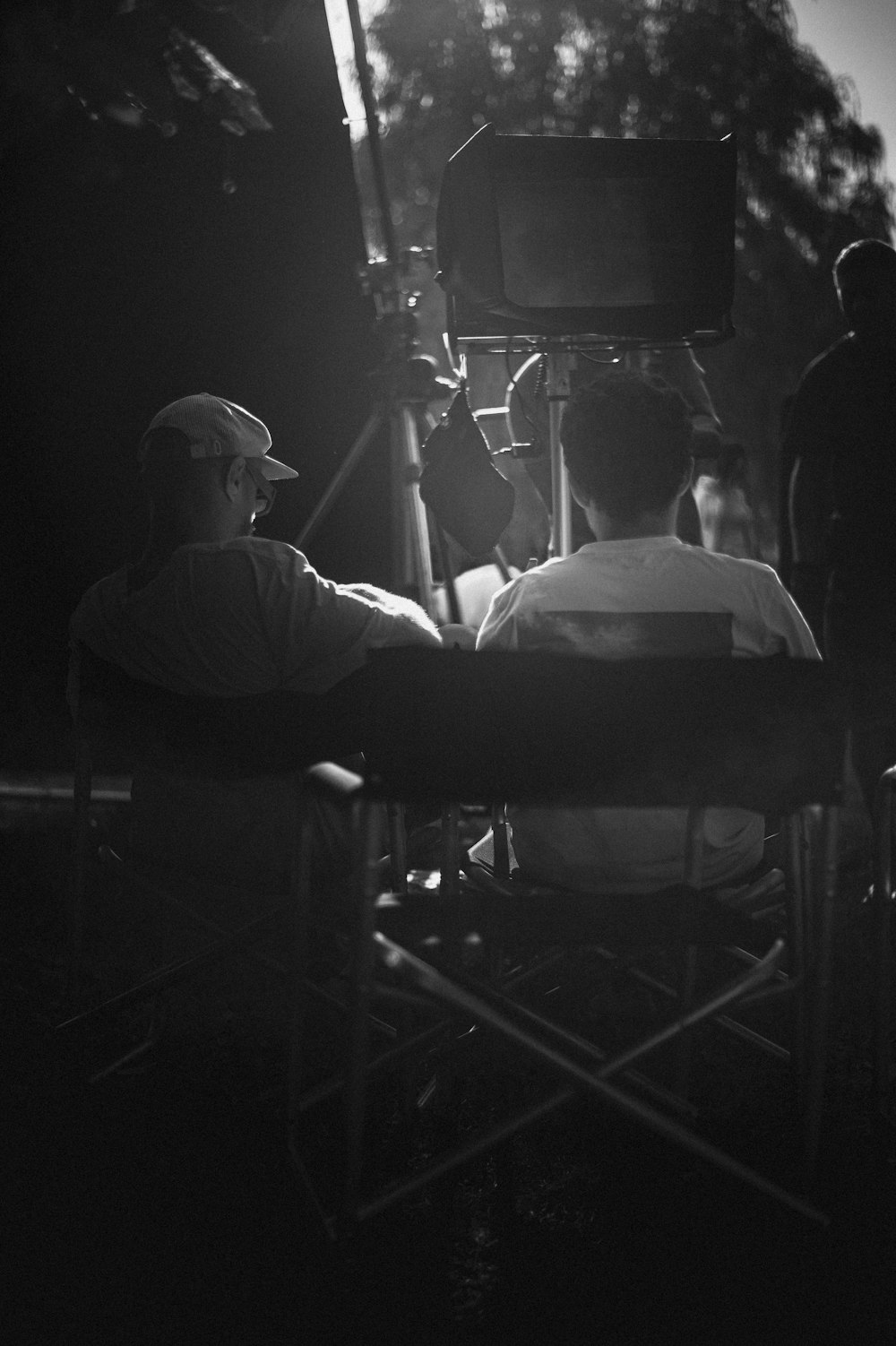 a black and white photo of a man sitting in a chair