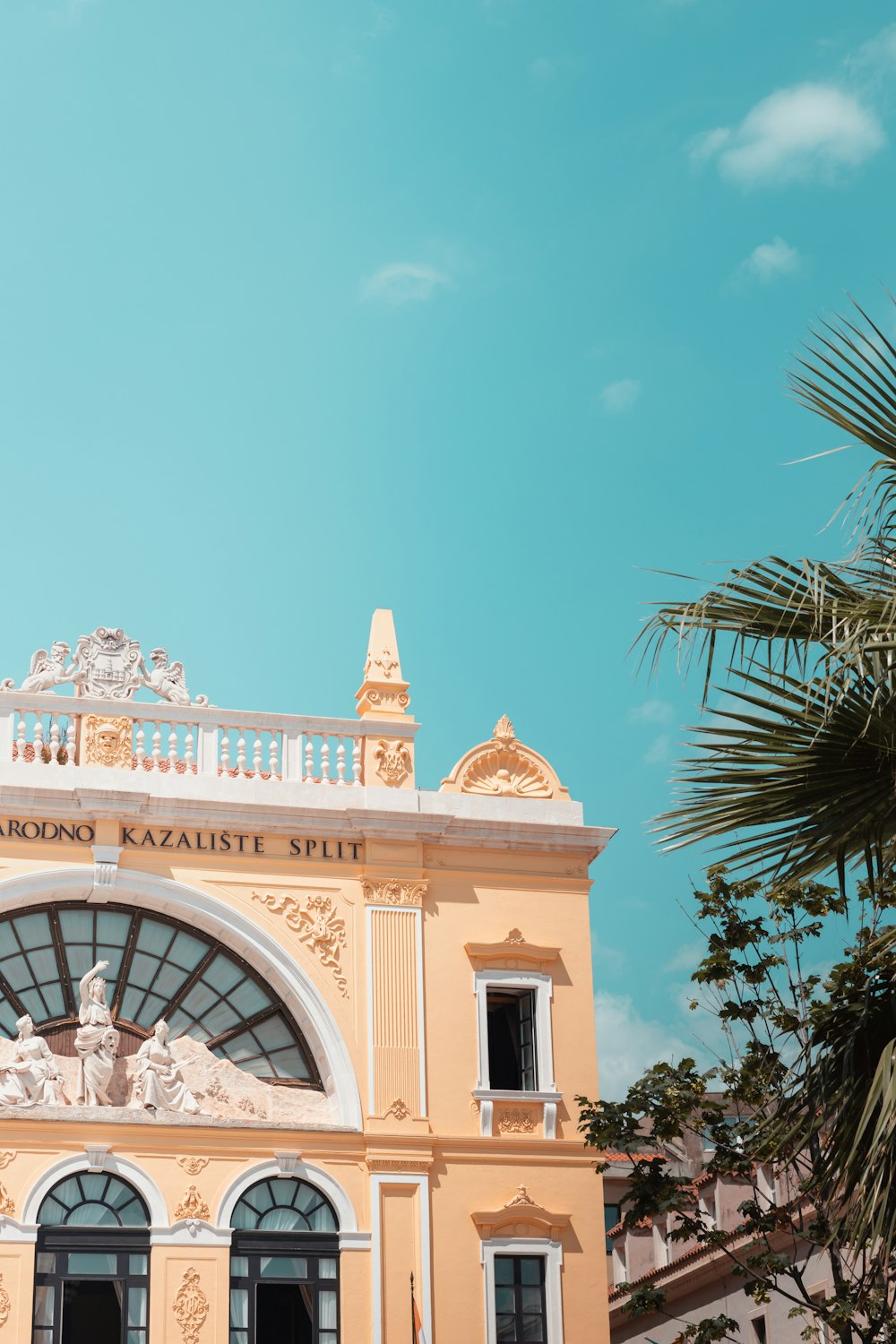 a yellow building with a clock on the top of it