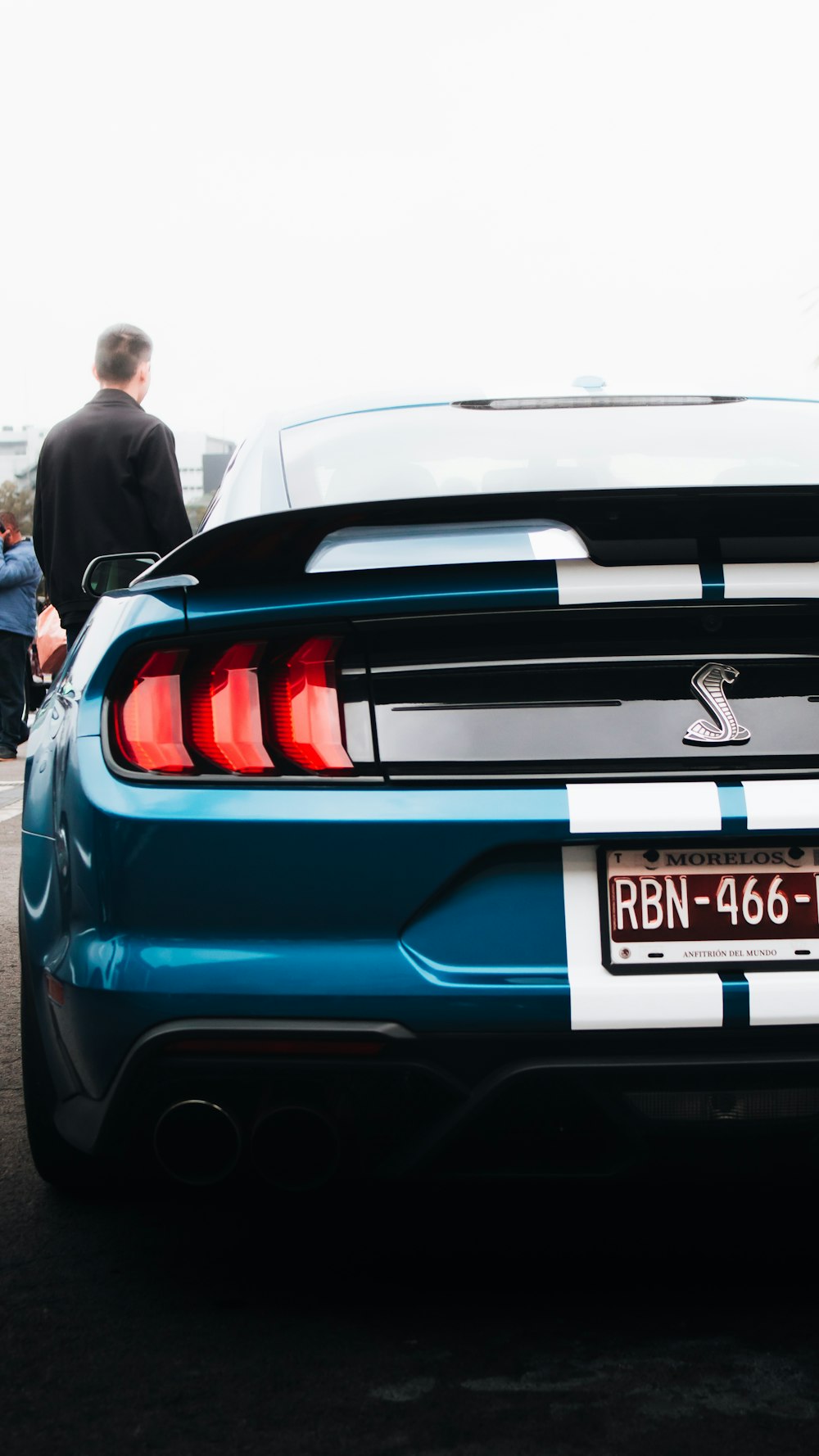 a blue sports car parked in a parking lot