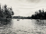 An old postcard showing the serene Kodaikanal Lake surrounded by vintage boats.