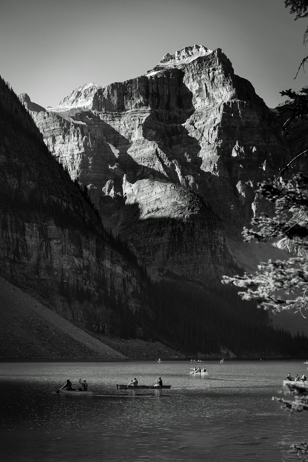 a black and white photo of a mountain lake