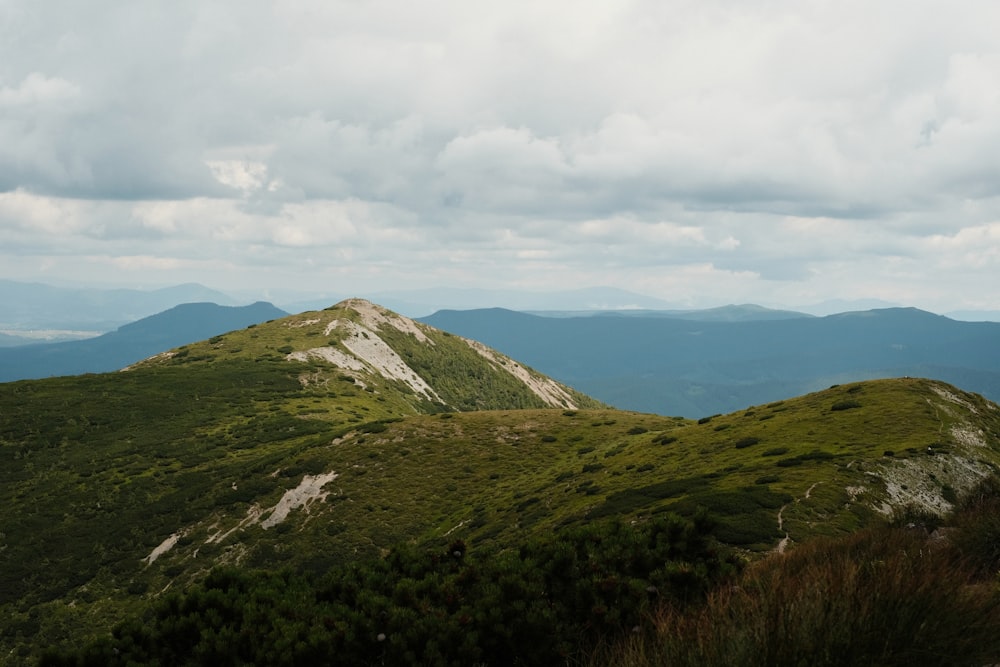 a view of a mountain range with clouds in the sky