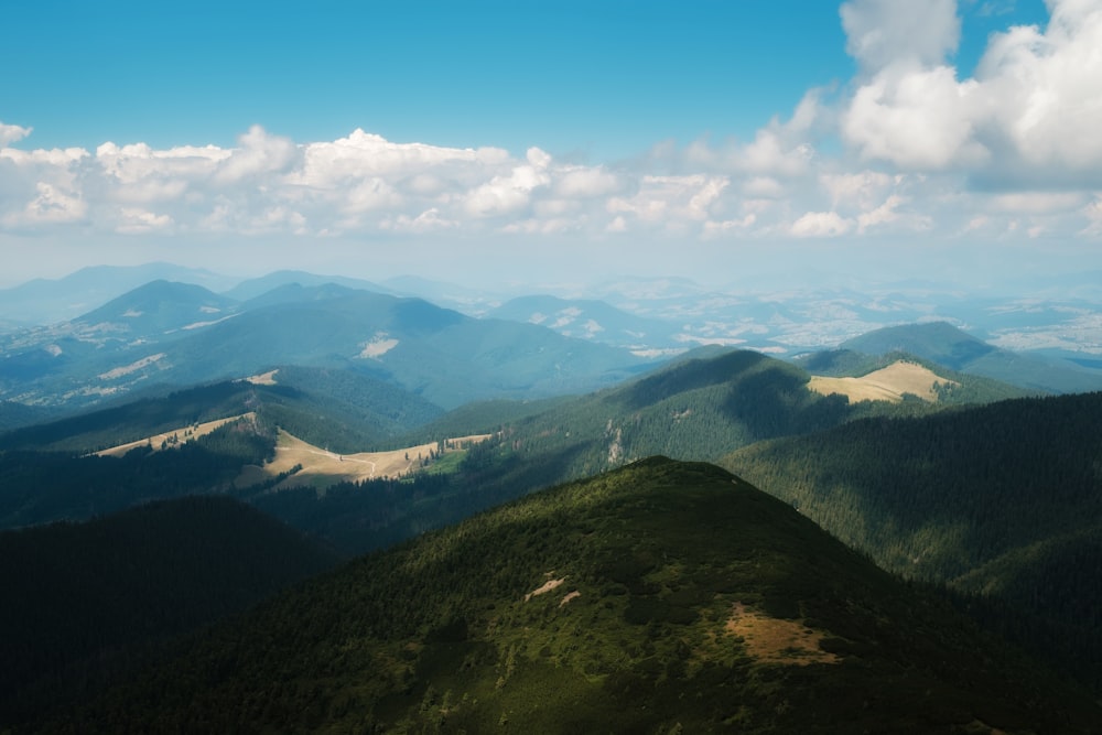 a view of a mountain range from the top of a hill