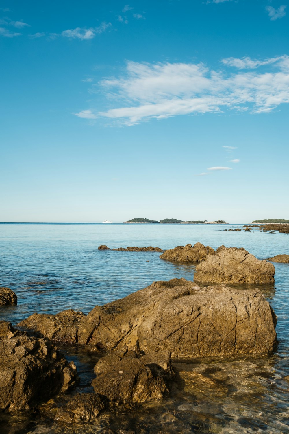 a rock outcropping in the middle of a body of water