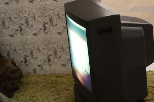 Vintage-style photo of a CRT television displaying a popular 90s cartoon intro with subtle glow.
