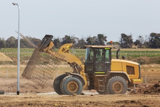 a bulldozer digging dirt in a field