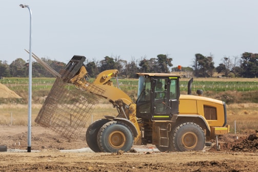 a bulldozer digging dirt in a field