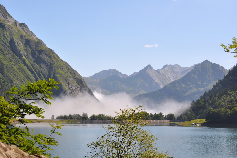 a body of water surrounded by mountains and trees