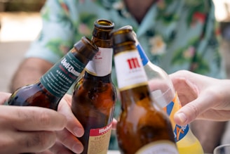 a group of people holding up beer bottles