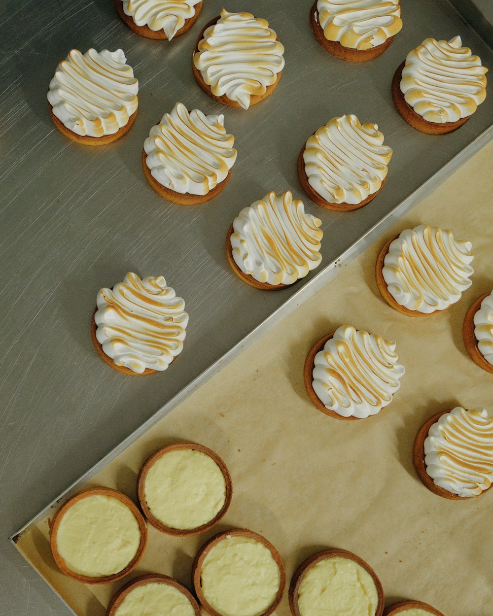 a tray of cookies with frosting on top of it