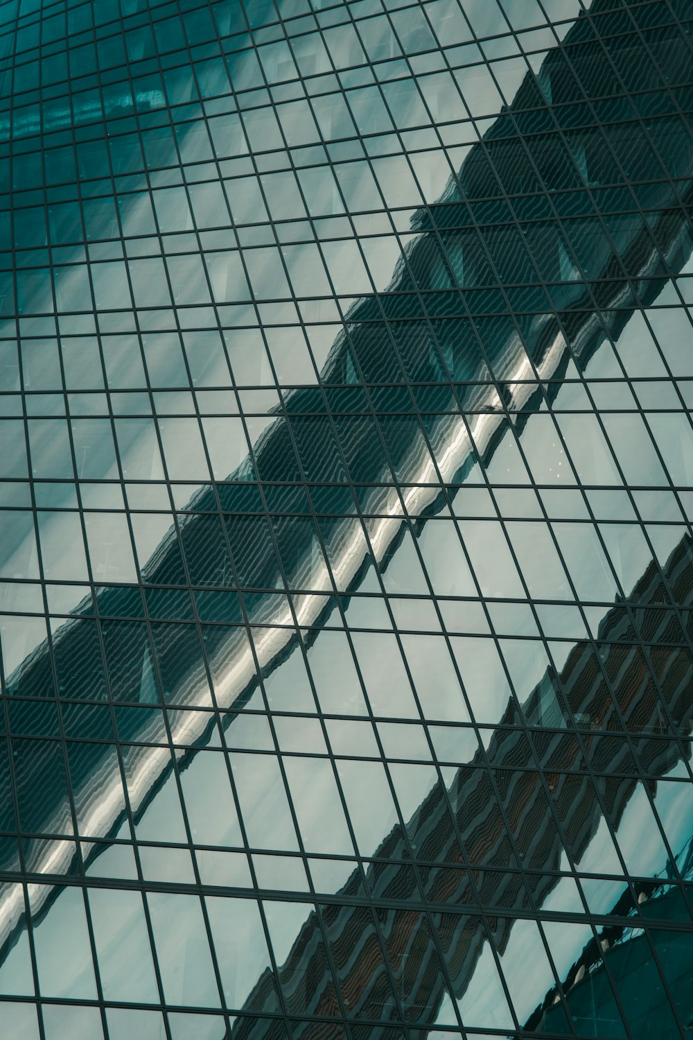 the reflection of a building in the glass of another building