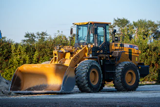 a large yellow bulldozer is parked on the side of the road