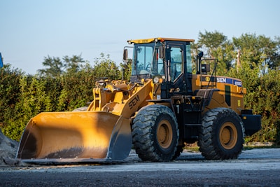 a large yellow bulldozer is parked on the side of the road