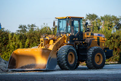 a large yellow bulldozer is parked on the side of the road