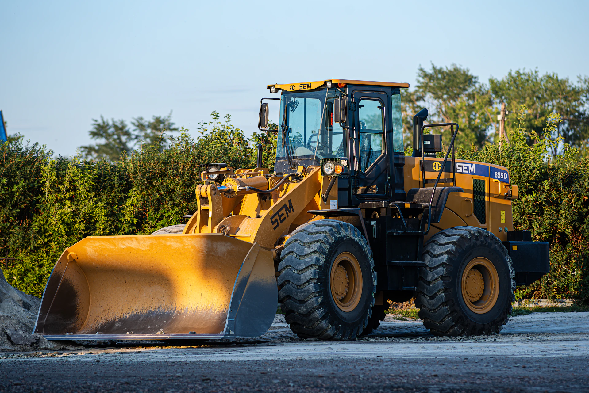 a large yellow bulldozer is parked on the side of the road