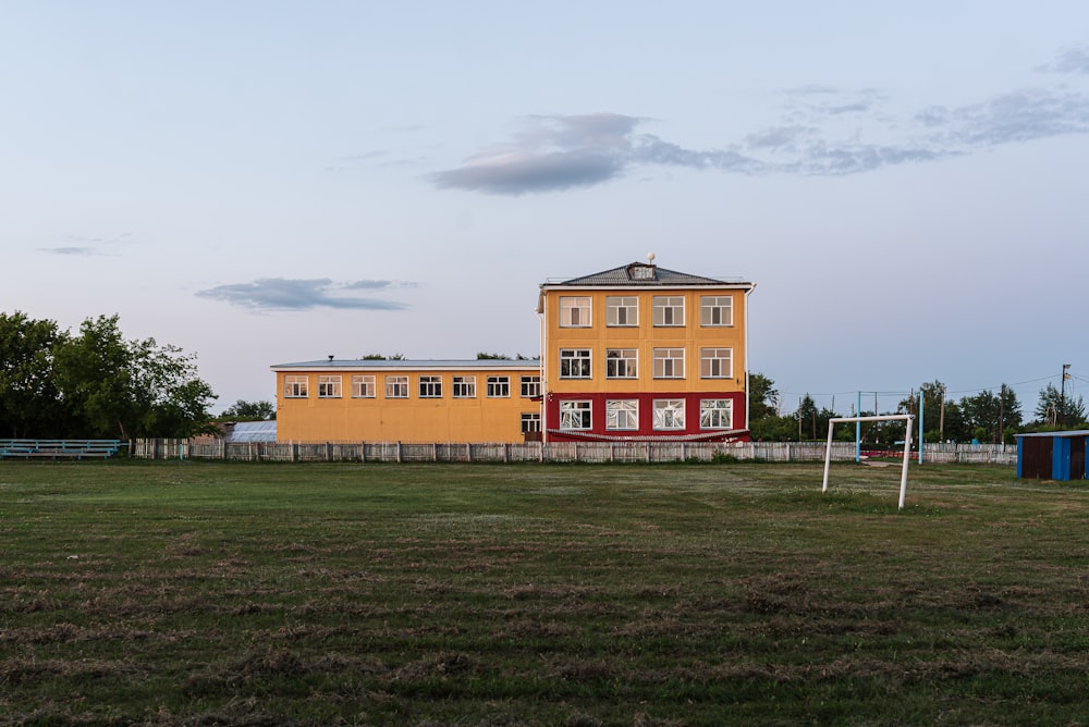 a soccer goal in front of a yellow building