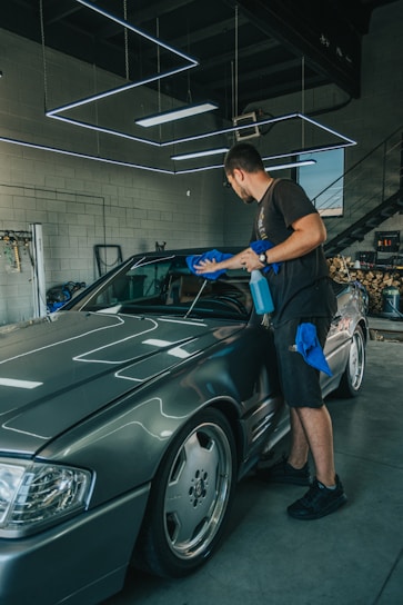 A shiny car undergoing detailed interior cleaning with professional equipment.