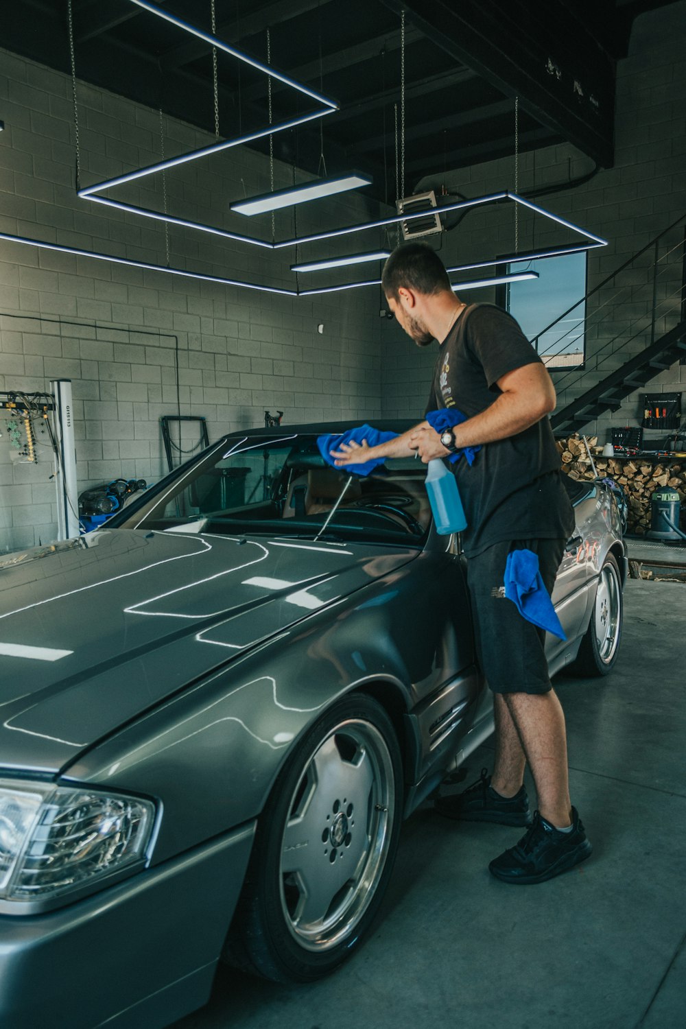 a man waxing a car in a garage