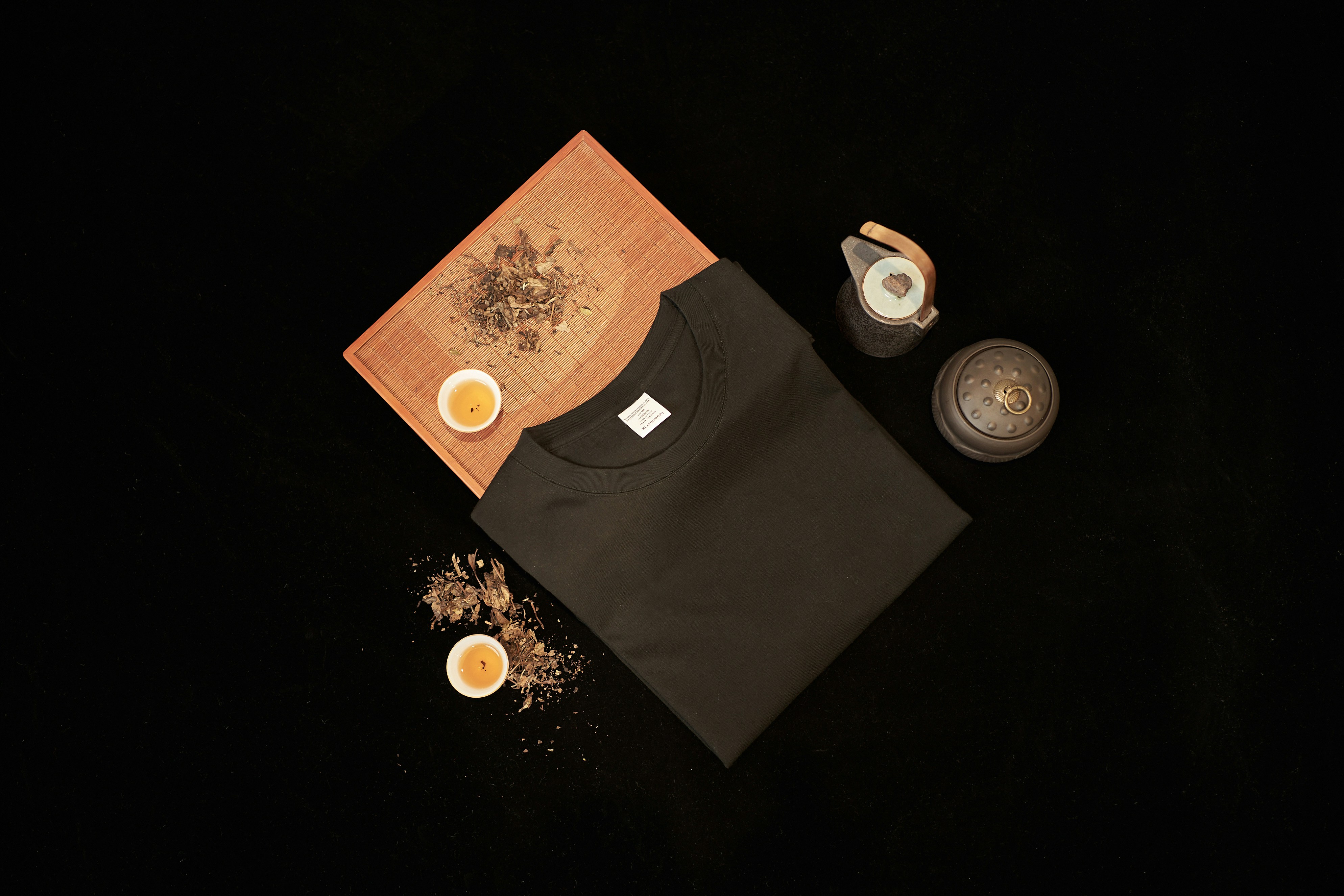 a table topped with a cutting board and cups of tea