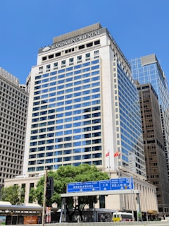 a tall building with a blue sign in front of it