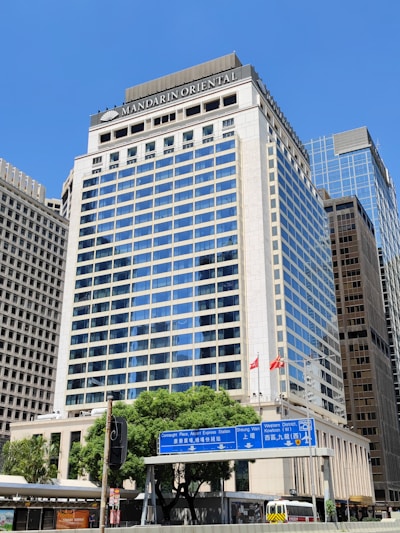 a tall building with a blue sign in front of it