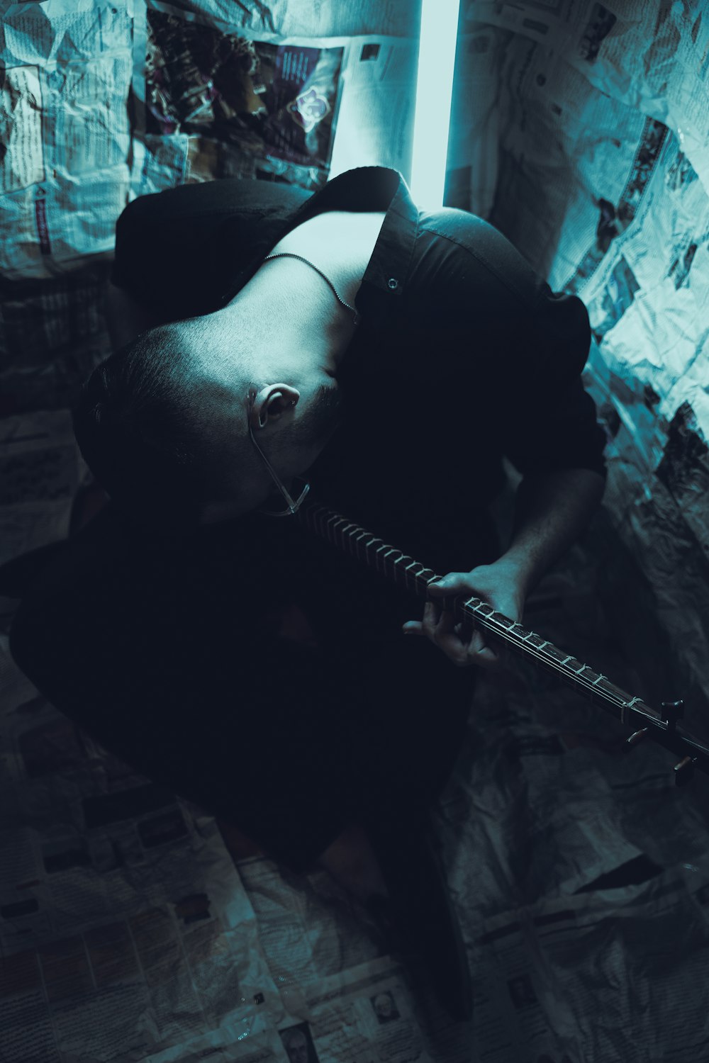 a man laying on the floor with a guitar
