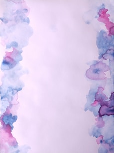 Close-up of hand-painted watercolor textures with stars and delicate borders.