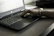 A stylish person wearing multiple sleek bracelets while typing on a laptop.