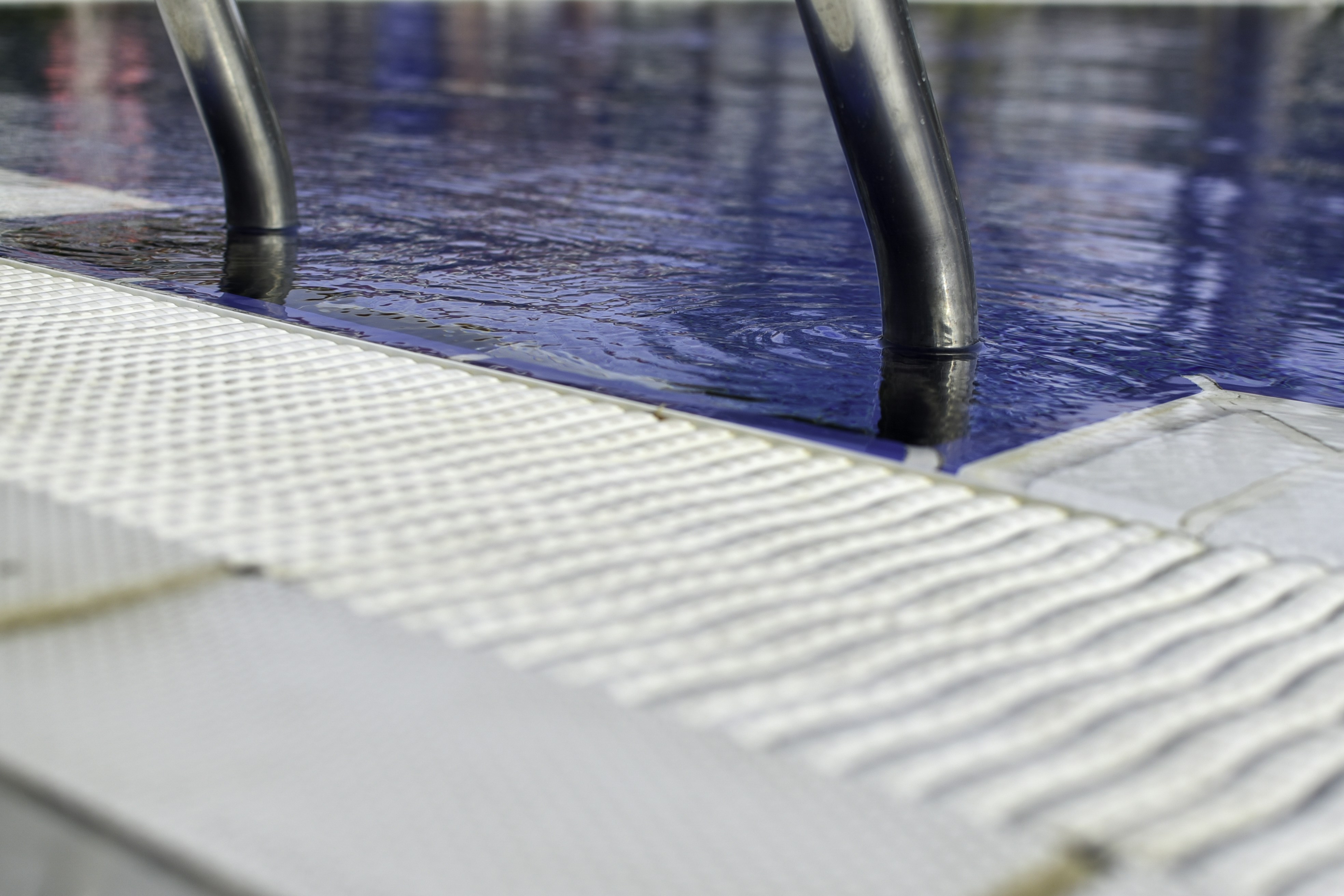 Swimming pool with metal railings