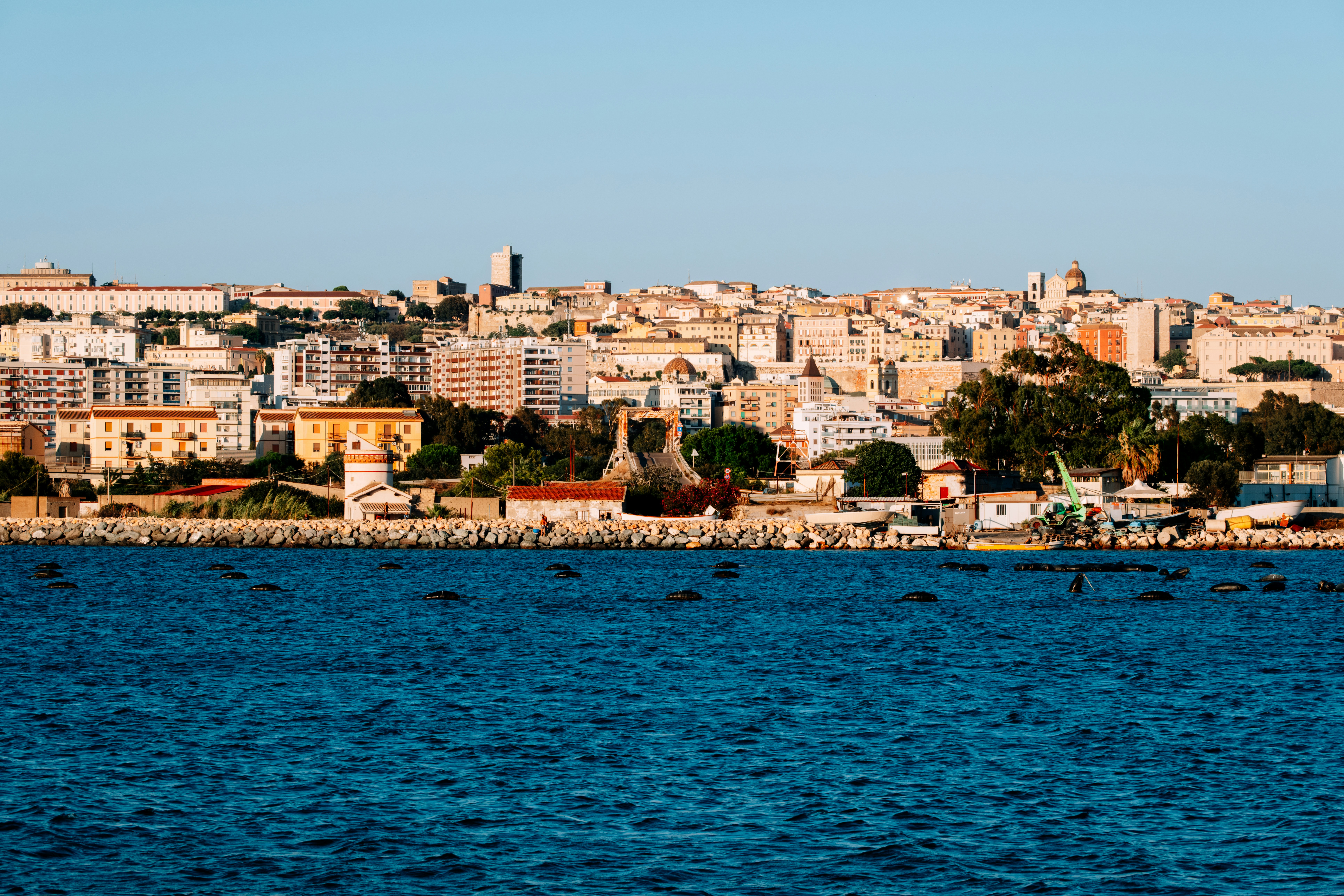 a large body of water with a city in the background