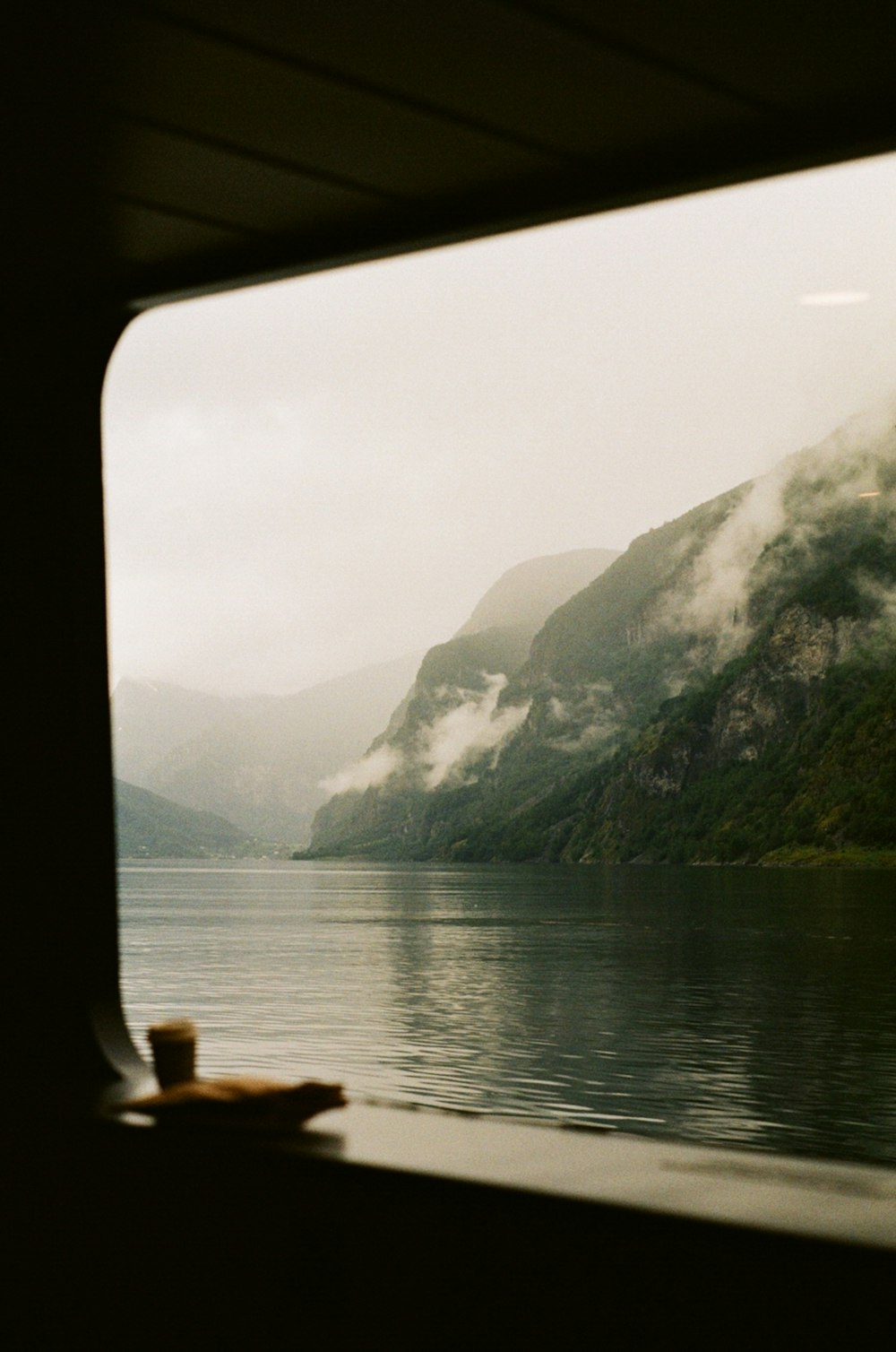 a view of a body of water with mountains in the background