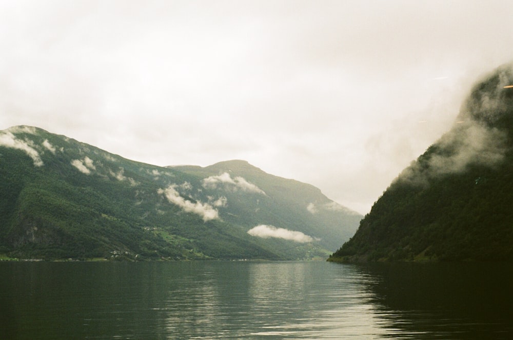 a body of water with mountains in the background