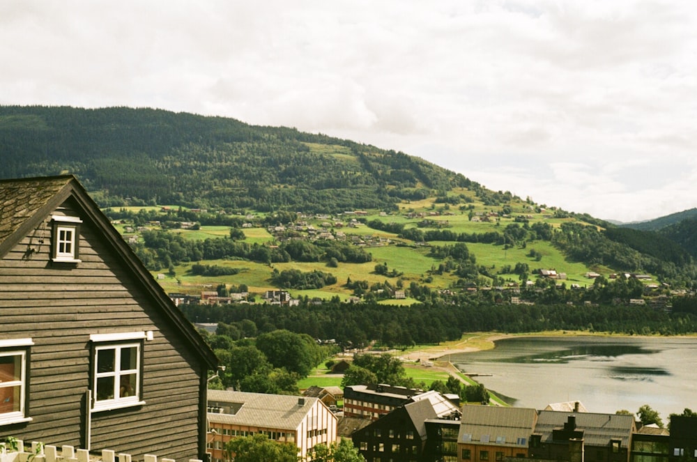 a view of a village and a lake from a hill