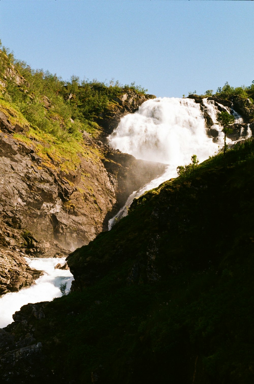 a view of a waterfall from the side of a hill