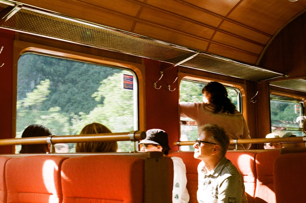 a group of people riding on a train next to each other