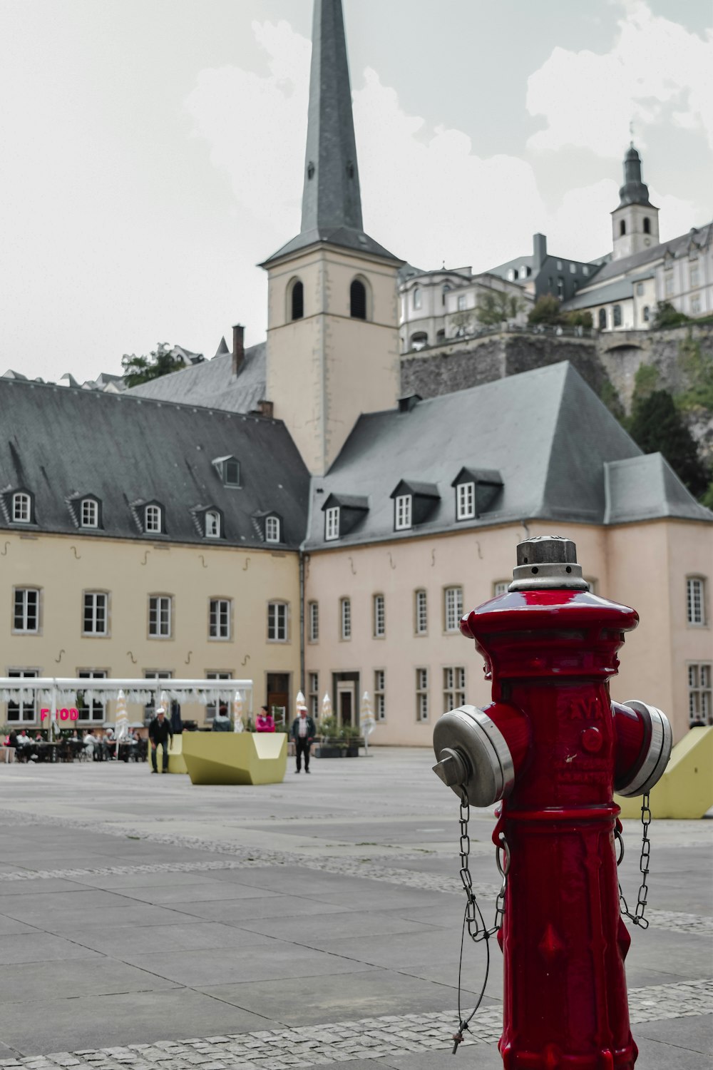 a red fire hydrant in front of a large building