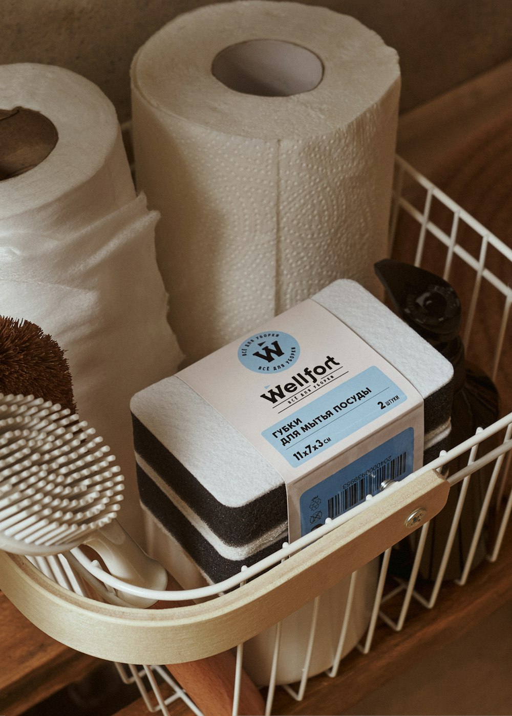 two rolls of toilet paper sitting on top of a basket